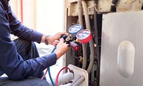 Technician is checking air conditioner ,measuring equipment for filling air conditioners.