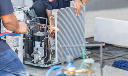 Close up of Air Conditioning Repair team use fuel gases and oxygen to weld or cut metals, Oxy-fuel welding and oxy-fuel cutting processes, repairman on the floor fixing air conditioning system