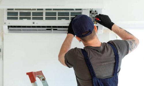 Technician repairing air conditioner